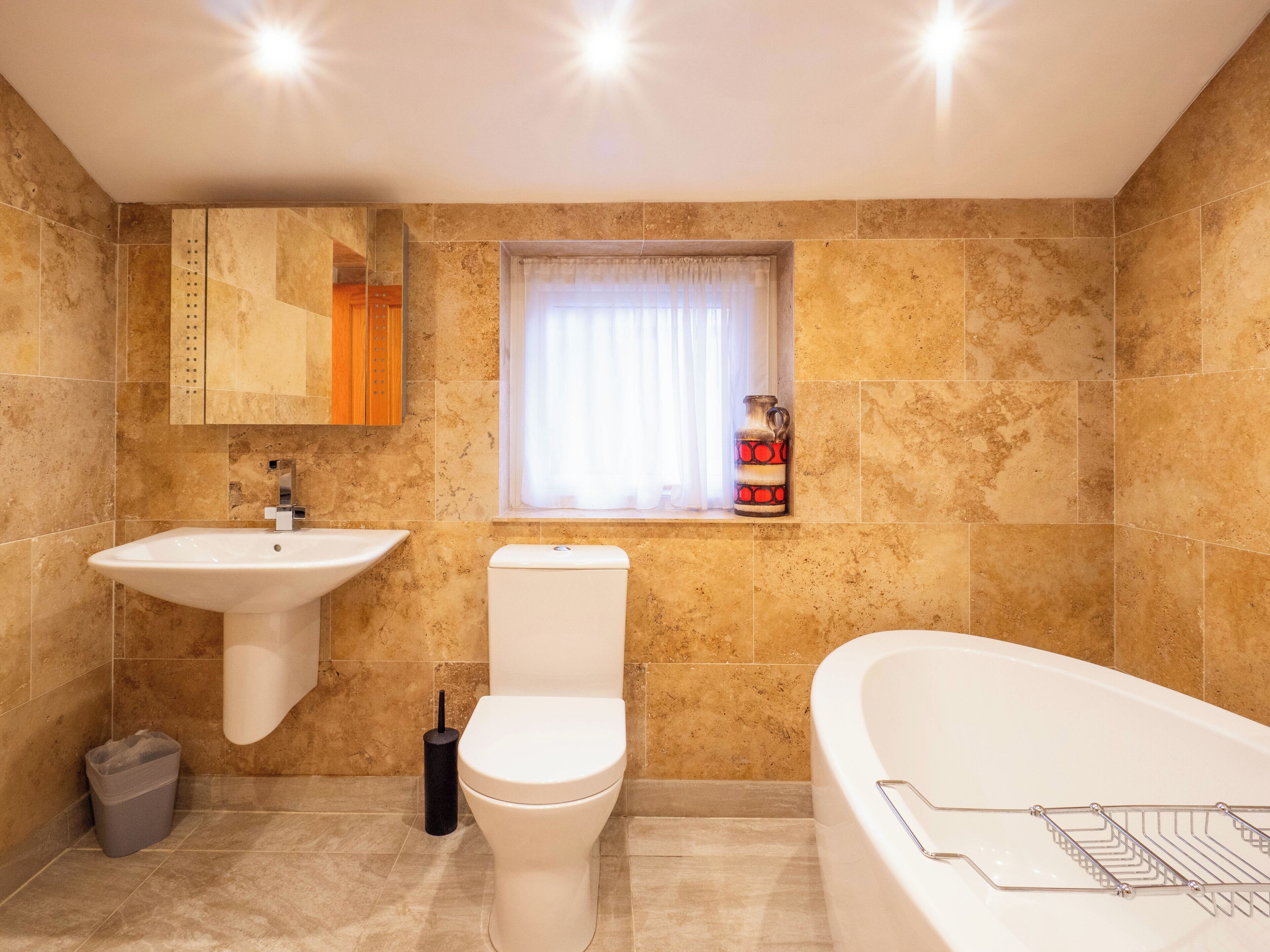 A bathroom with a sink, toilet, and bathtub.