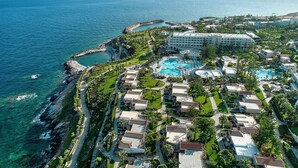 A coastal resort with a large pool, beachfront villas, and a rocky shoreline. - Iberostar Waves Creta Panorama & Mare (Mylopotamos)