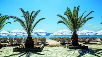 On the beach, sun-loungers, beach umbrellas, beach volleyball