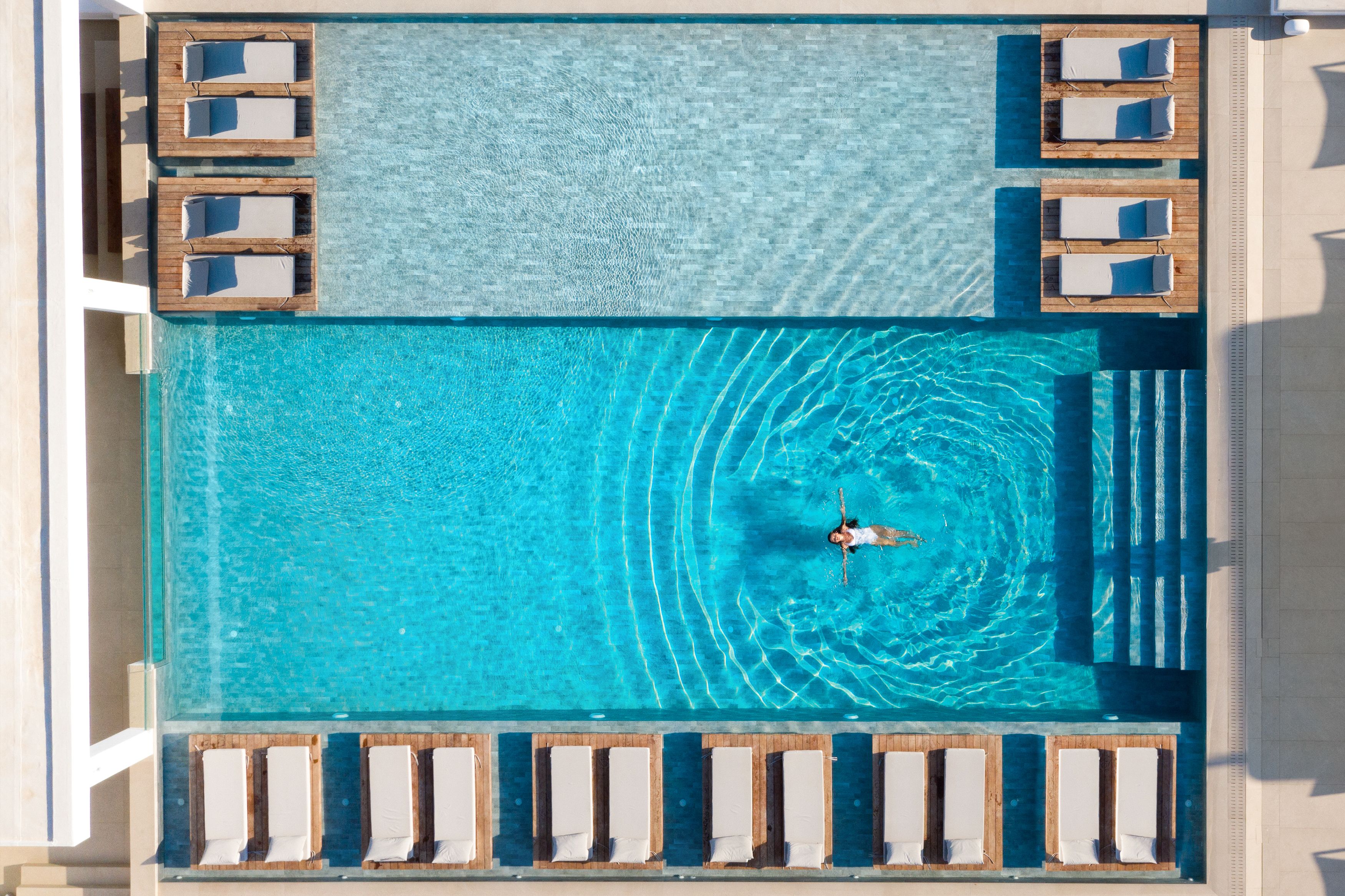 outdoor pool, open 10:30 am to 8:00 pm, pool umbrellas, pool loungers