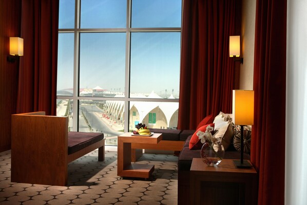 Premium Suite, 1 King Bed | Living area | 32-inch LCD TV with satellite channels, TV