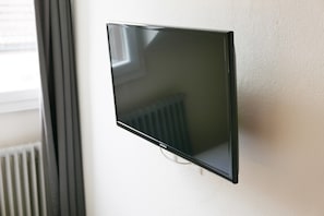 Enjoy in-room entertainment with a wall-mounted flat-screen TV.