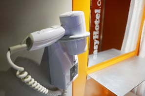 Guests can use the hairdryer and access power outlets in this functional room.