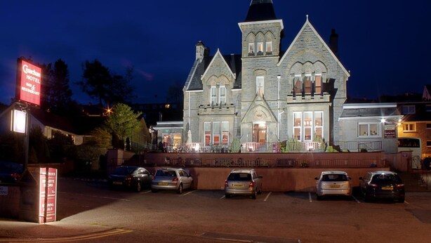 A historic building with a prominent tower and multiple windows, labeled as a hotel. - Cruachan Hotel (Fort William)