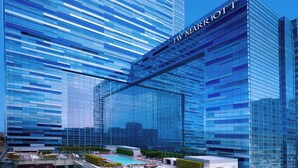 A JW Marriott hotel with a modern glass facade, a rooftop pool, and a landscaped terrace. - JW Marriott Los Angeles L.A. LIVE (Los Angeles)