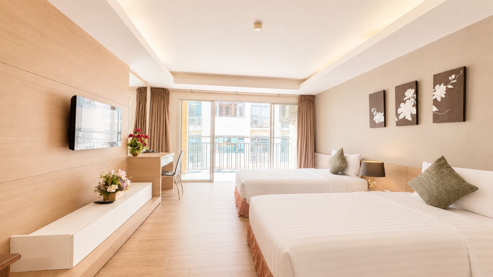 A hotel room with two beds, a TV, a desk, a chair, a window, and a balcony.