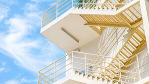 A multi-level outdoor staircase with railings and a clear sky in the background. - Olive Hotel & Residence Bangkok Sukhumvit 101 near True Digital Park (Bangkok)