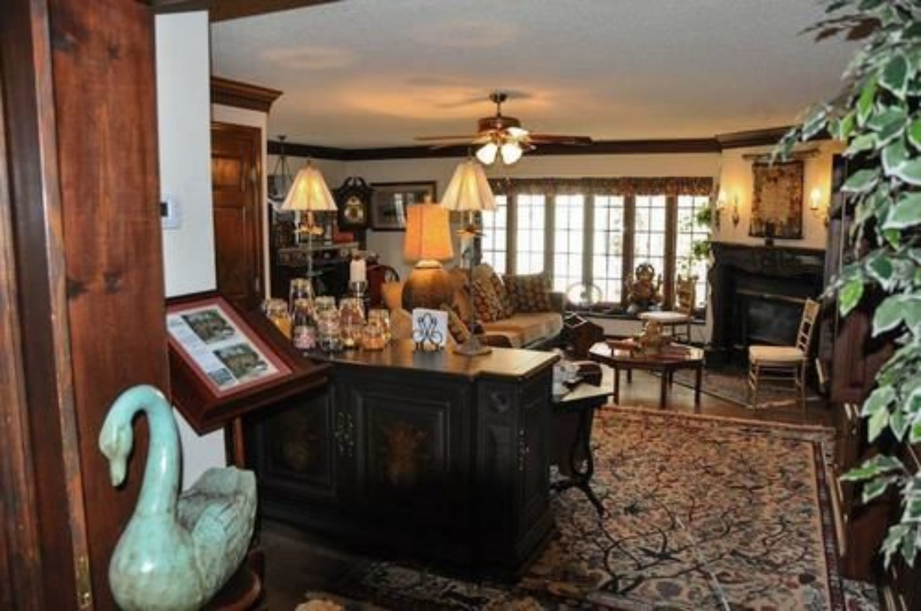 A traditional living room with a fireplace, a wooden coffee table, and a sofa.