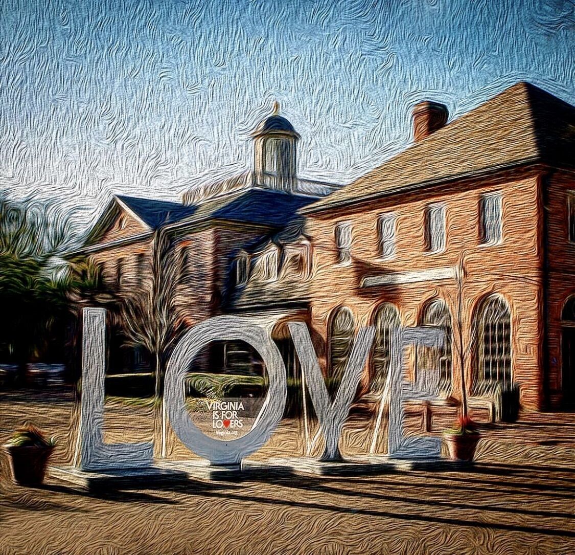 A large building with a prominent 'LOVE' sign in front.