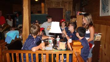 Guests can enjoy a casual game night in this cozy room with a wooden table and comfortable seating.