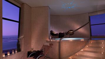Enjoy a panoramic ocean view from the comfort of your room, featuring a hot tub and a curved staircase.