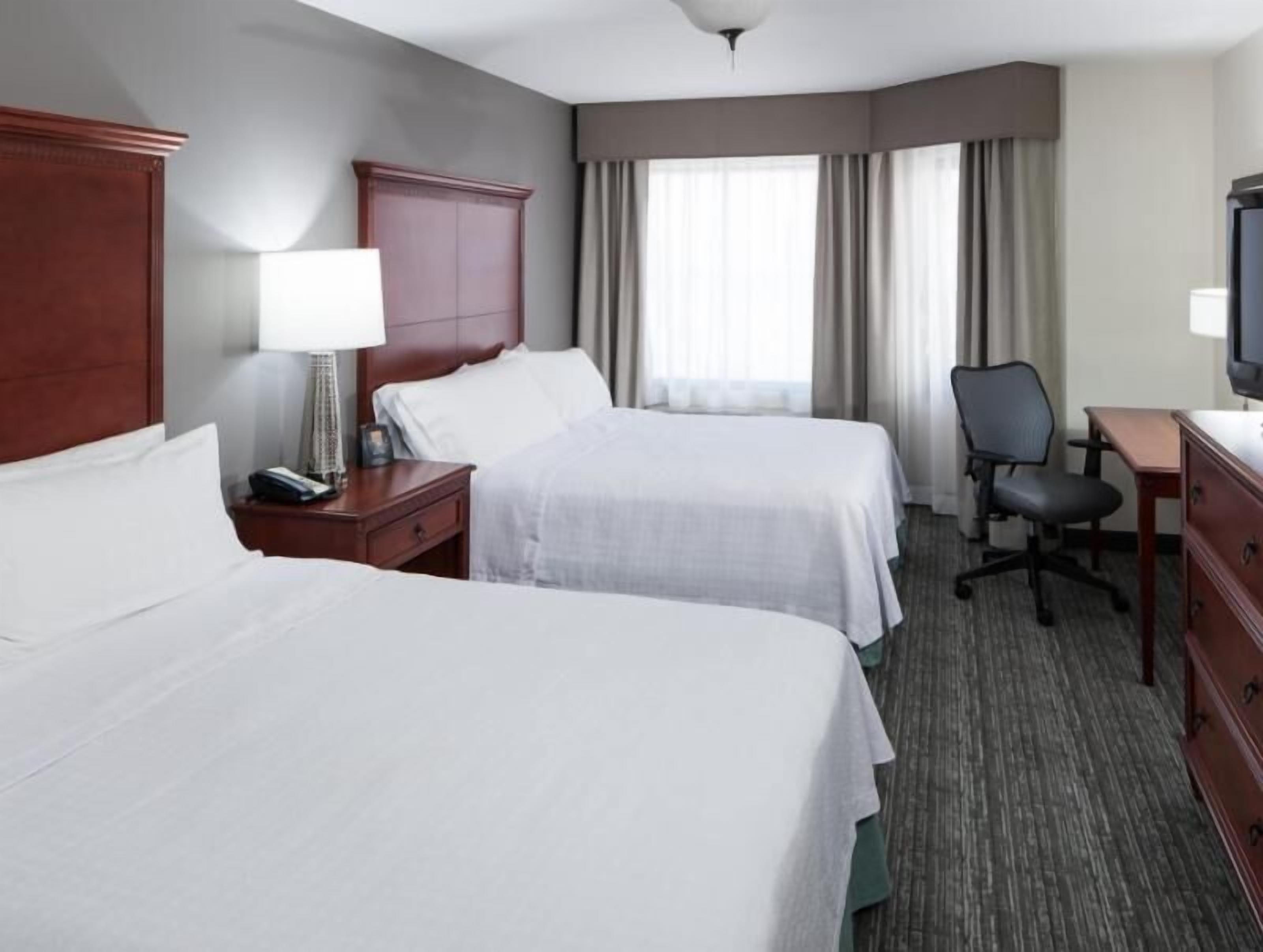 Premium bedding, pillowtop beds, laptop workspace, blackout drapes