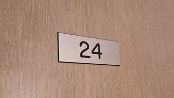 A wooden door with a number label '24'.