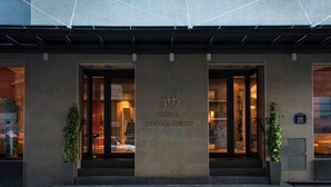 Entrada de un hotel con un letrero que dice "HOTEL TOWNHOUSE 27".