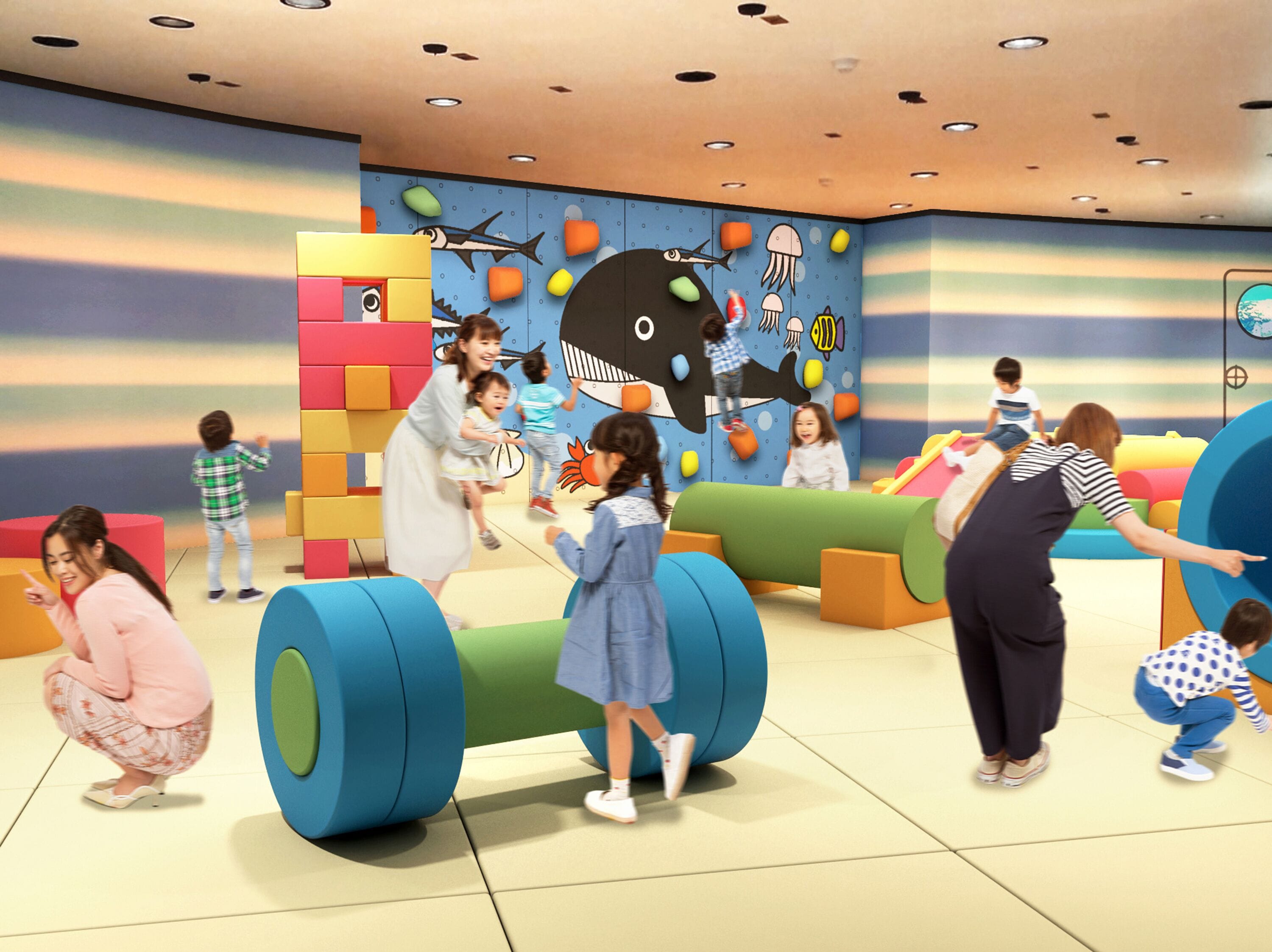 A children's play area with colorful play structures and a mural of sea creatures.
