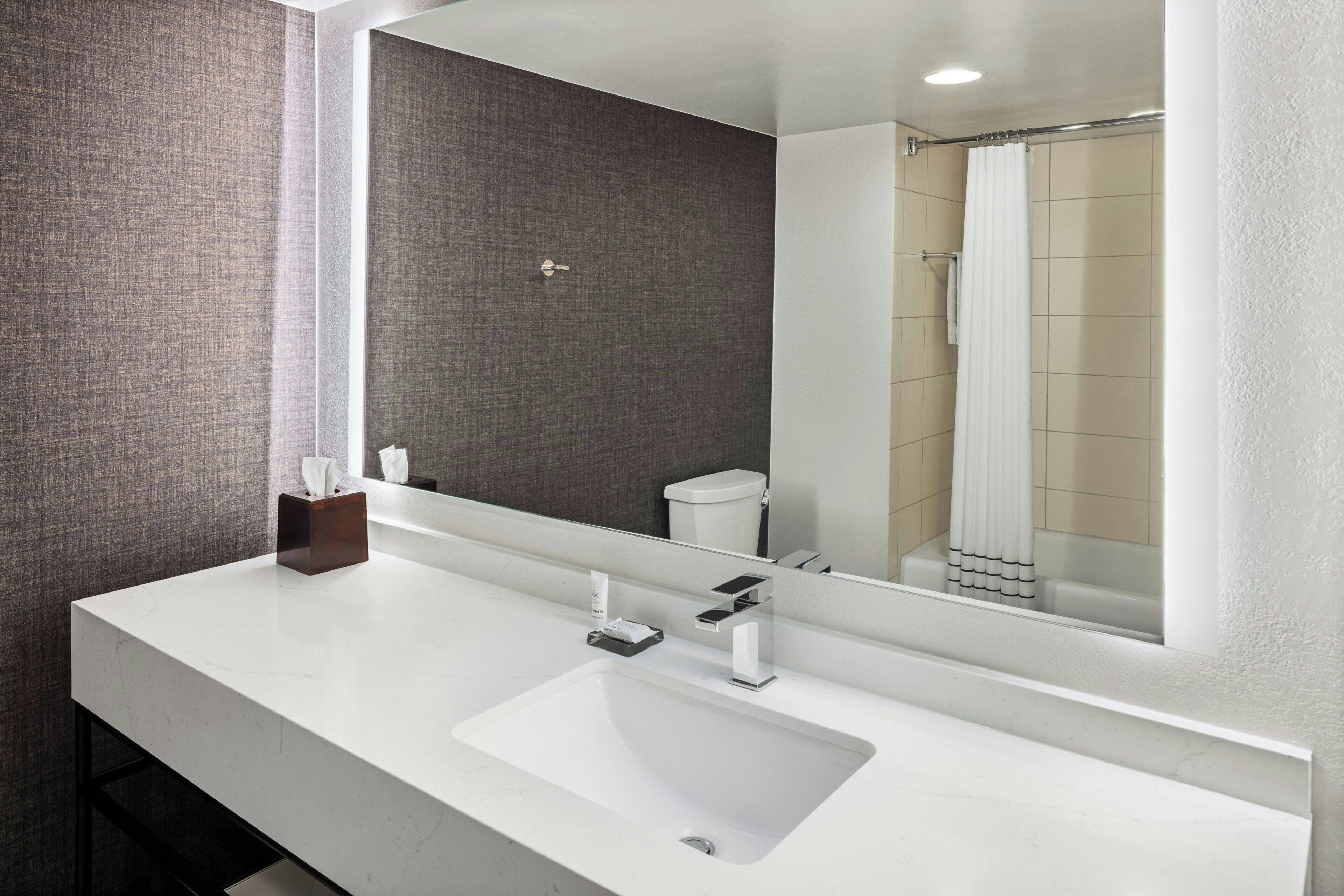 combined shower/bathtub, designer toiletries, hair dryer, towels