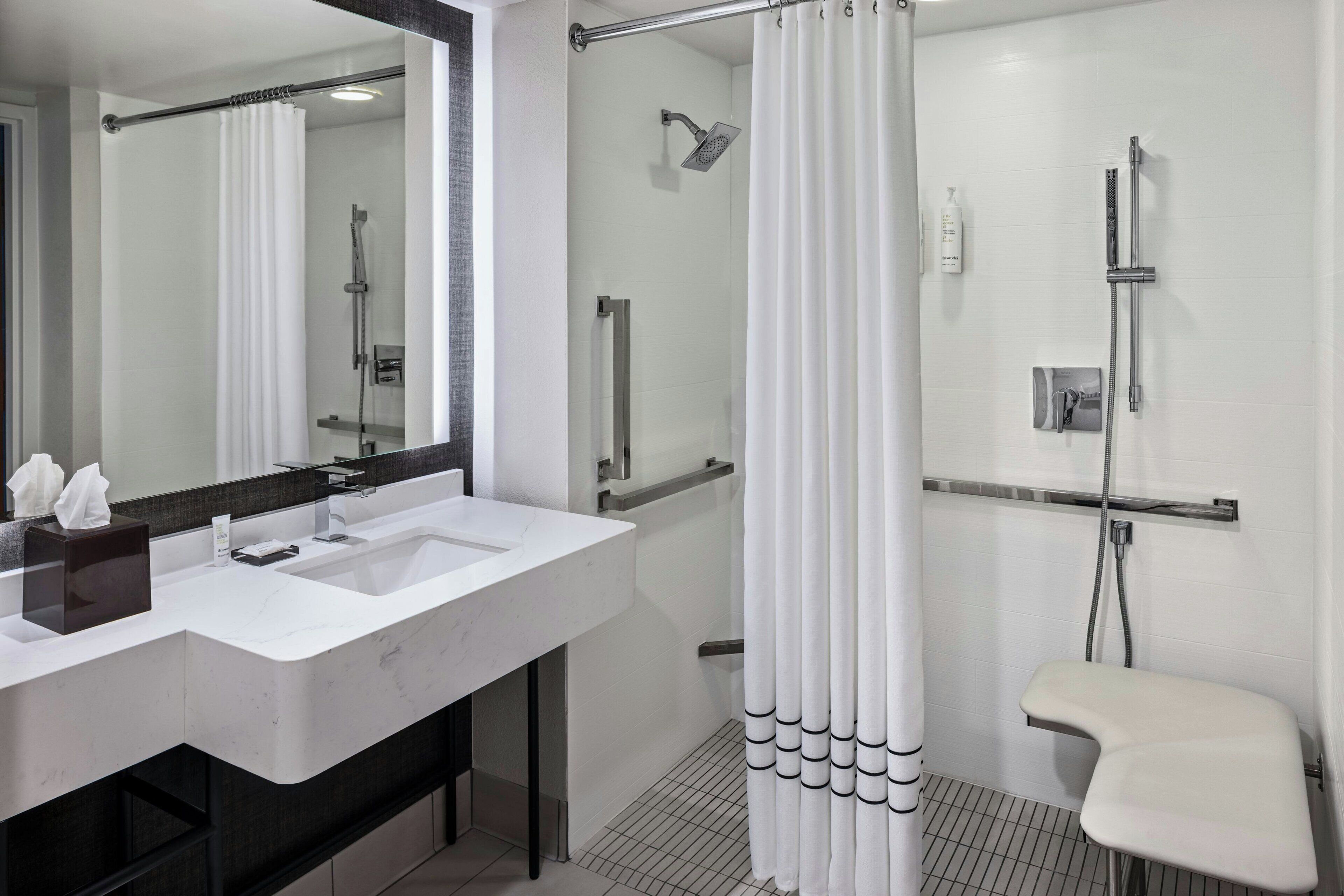 combined shower/bathtub, designer toiletries, hair dryer, towels