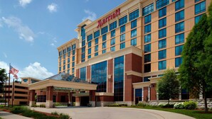 A Marriott hotel with a modern facade, large windows, and a covered entrance area. - Bloomington-Normal Marriott Hotel & Conference Center (Normal)