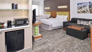 A hotel room with a bed, a sofa, a TV, a microwave, and a coffee maker. - SpringHill Suites by Marriott Ashburn Dulles North (Ashburn)