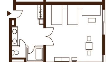 A floor plan of a hotel room with a kitchenette, a sitting area with a sofa and chairs, and a small table.