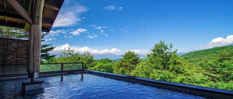 An infinity pool with a clear view of a mountainous landscape.