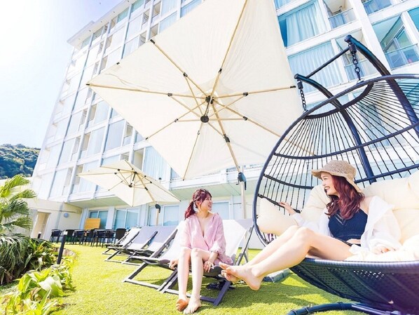 A rooftop lounge with outdoor seating and umbrellas.