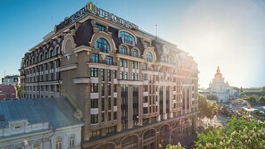 A multi-story building with a classical architectural style, featuring large windows and decorative elements.