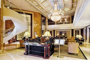 A luxurious lobby with a grand staircase, elegant furniture, and a chandelier. - InterContinental Kyiv by IHG (Kyiv)