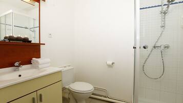 Een badkamer met een wastafel, toilet en douche.