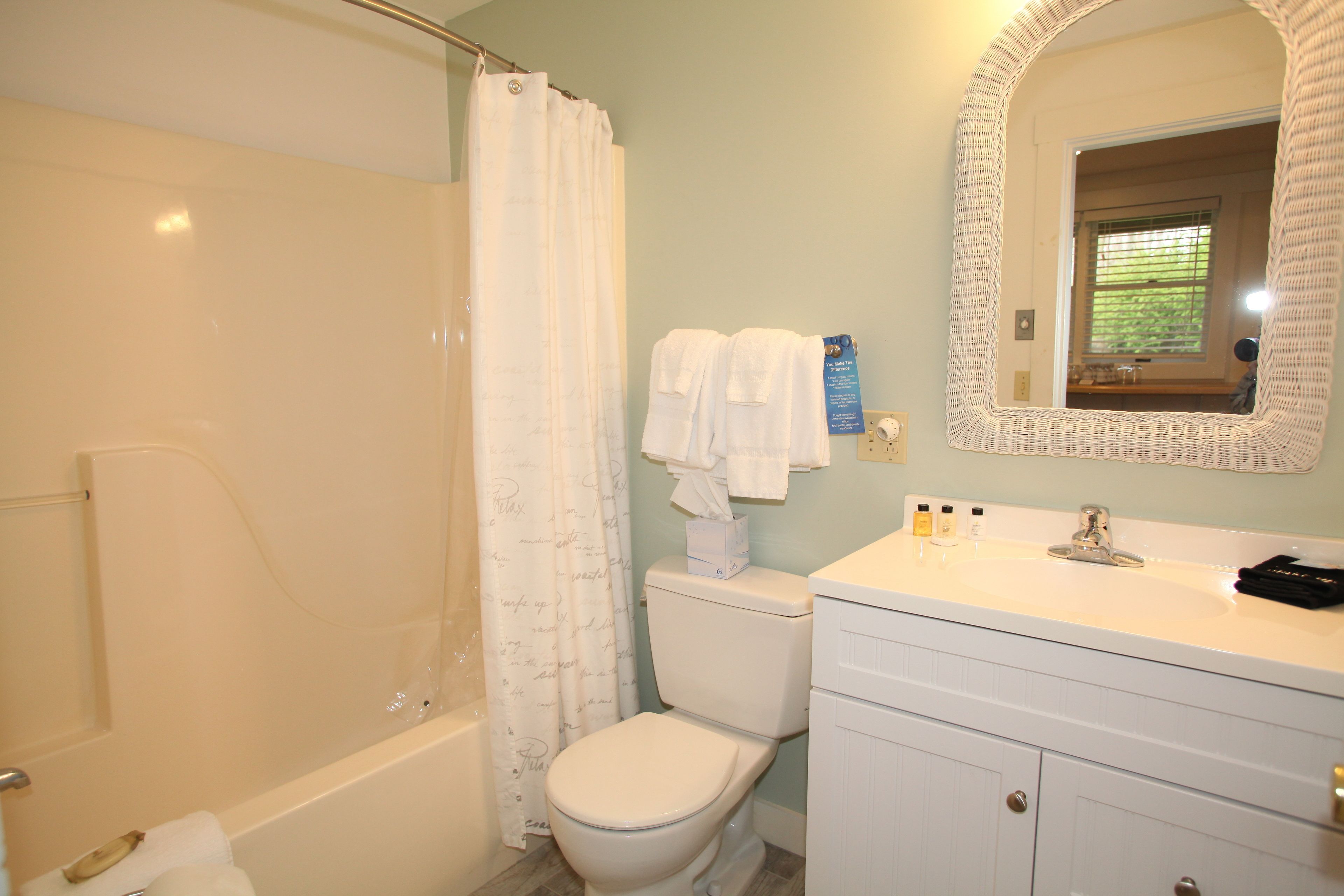 A bathroom with a bathtub, toilet, and sink.