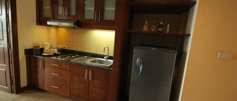 A kitchen with wooden cabinets, a stainless steel sink, and an LG refrigerator.