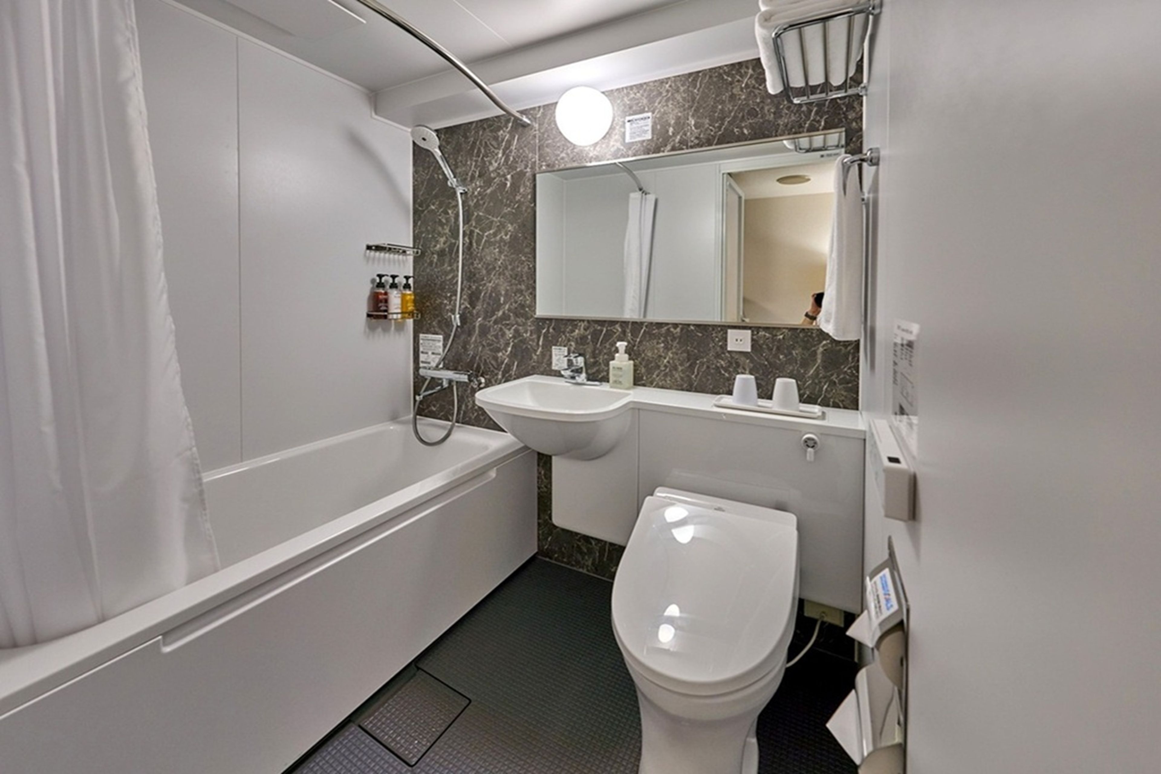 A bathroom with a bathtub, a sink, and a toilet.