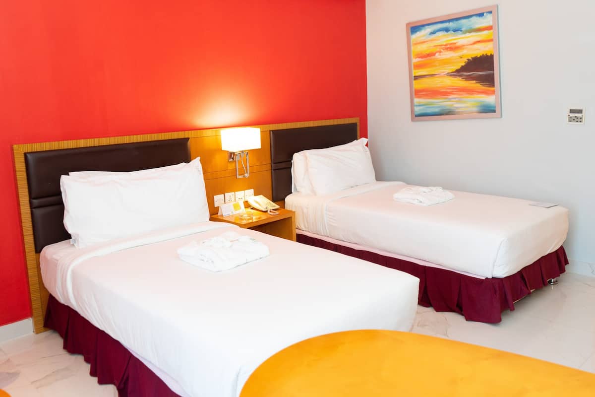 A hotel room with two beds, a nightstand with a lamp, a painting on the wall, and a yellow chair.