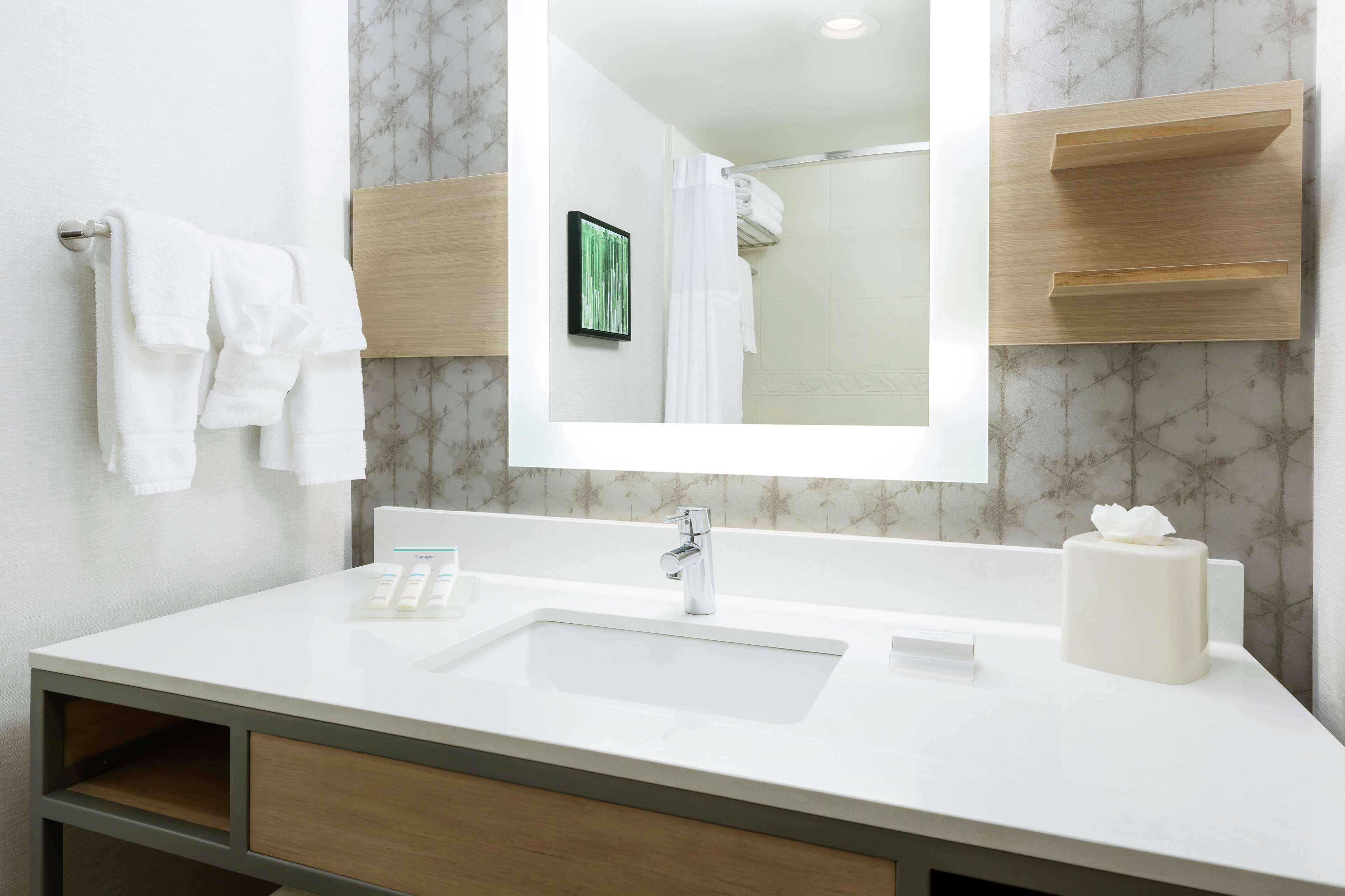 combined shower/bathtub, designer toiletries, hair dryer, towels