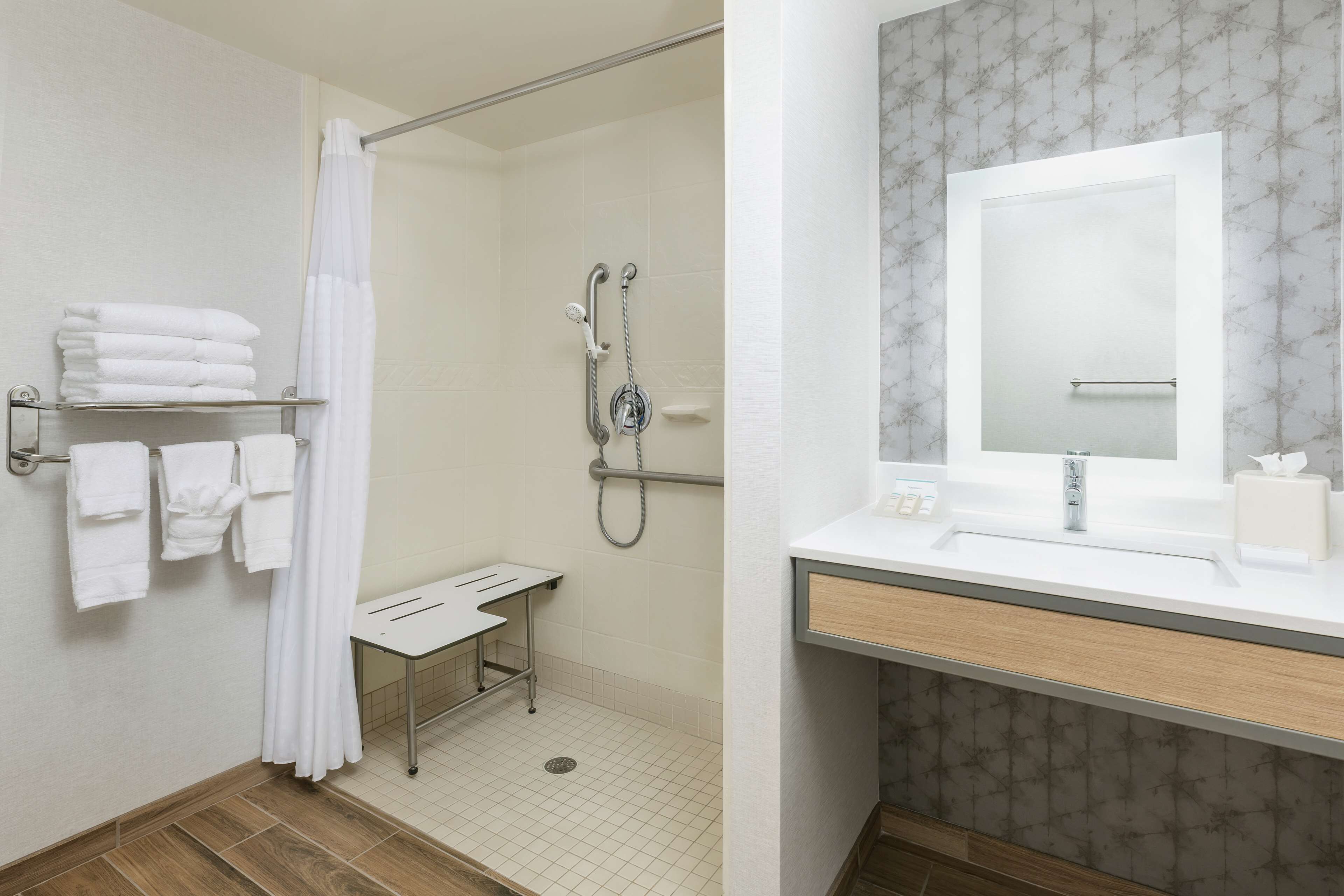 combined shower/bathtub, designer toiletries, hair dryer, towels