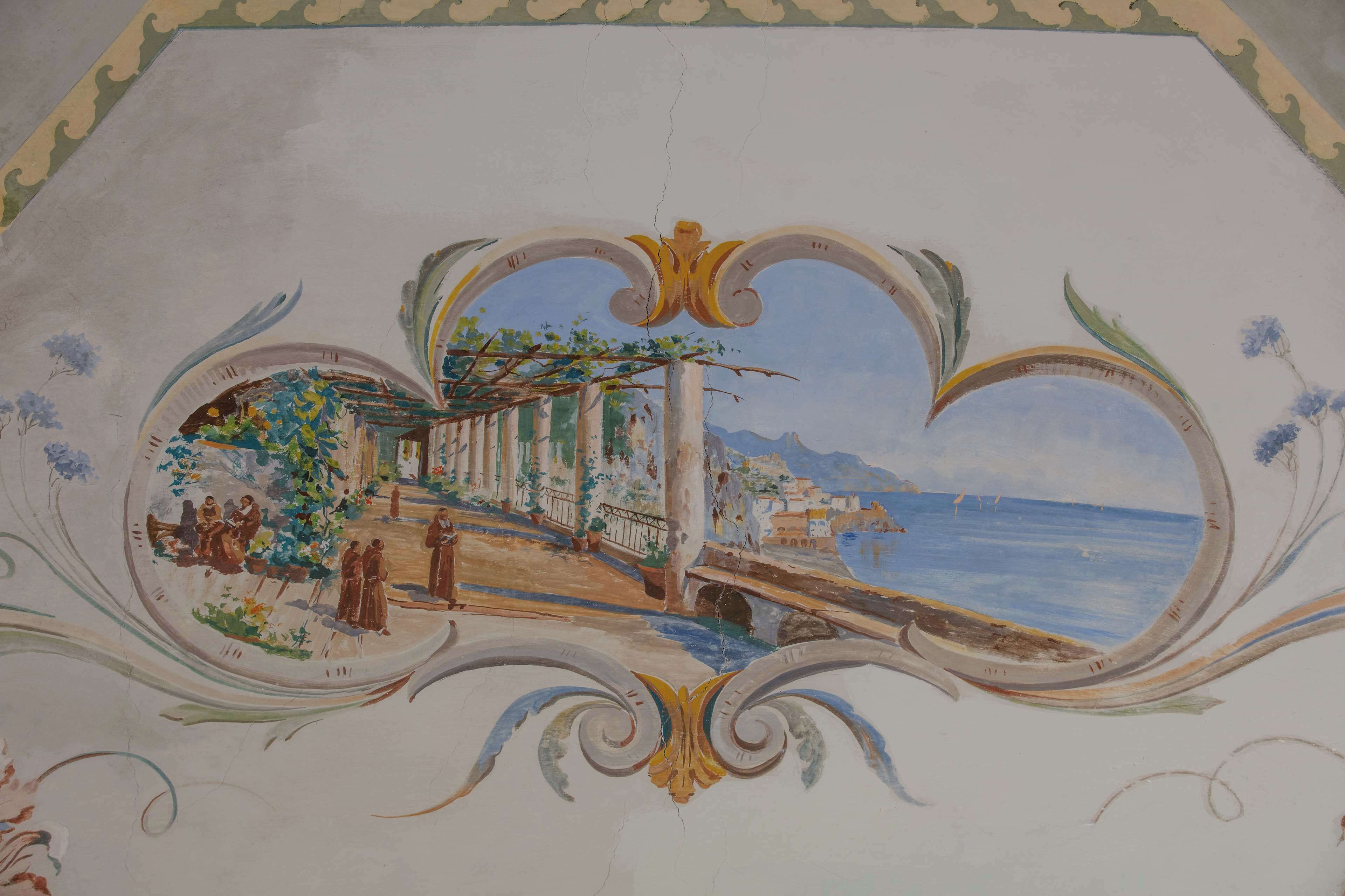 A ceiling fresco with a coastal scene, architectural columns, and a bridge.