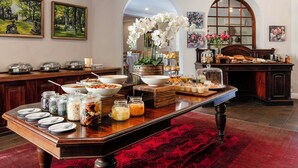 A buffet setup with various food items and a decorative centerpiece. - Murray Street 137 Guest House (Pretoria)