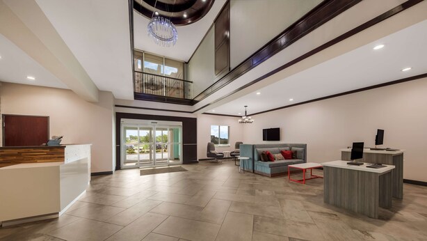 A spacious lobby with a reception desk, seating area, and a balcony. - Best Western Plus Bowie Inn & Suites (Bowie)