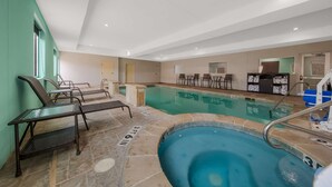 An indoor swimming pool with lounge chairs and a hot tub. - Best Western Plus Bowie Inn & Suites (Bowie)