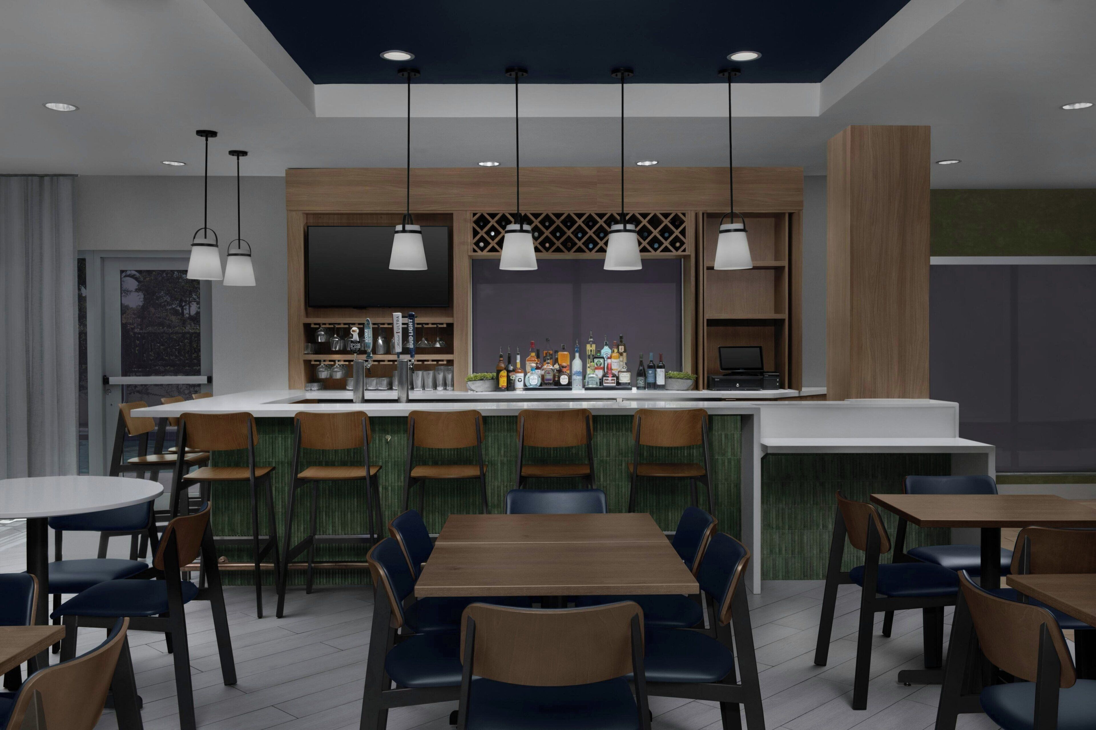 A modern restaurant with a bar area, multiple seating options including round tables and booths, and pendant lighting.