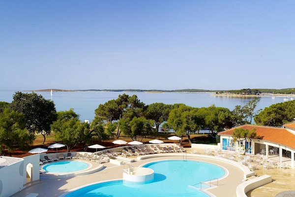Indoor pool, 2 outdoor pools, open 8 AM to 9 PM, pool umbrellas
