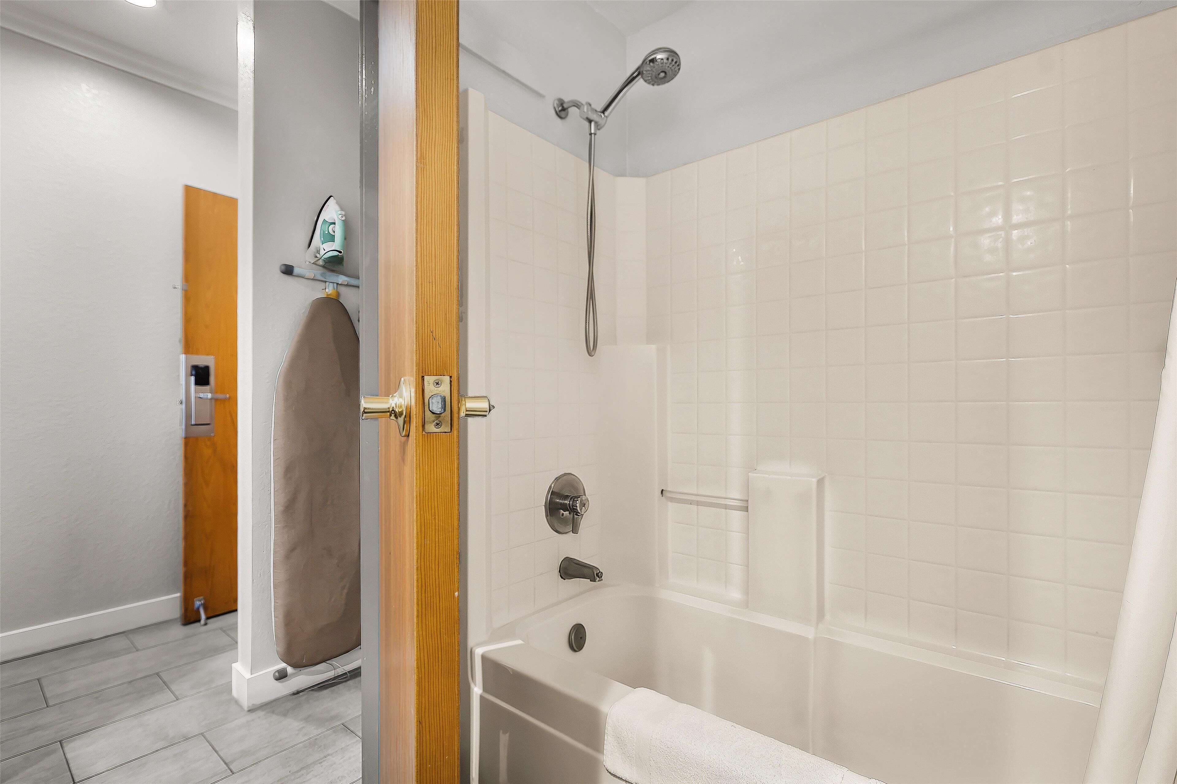 A modern bathroom with a shower, a bathtub, and a toilet.