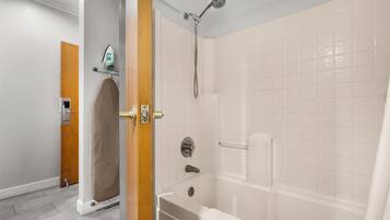 A modern bathroom with a shower, a bathtub, and a toilet.