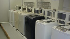 A row of industrial-style water dispensers in a clean, utilitarian setting. - Kushiro Prince Hotel (Kushiro)