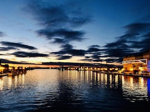 A waterfront view at dusk with illuminated buildings and a calm river reflecting the lights. - Kushiro Prince Hotel (Kushiro)
