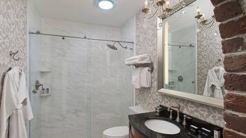 A bathroom with a shower, toilet, and sink.