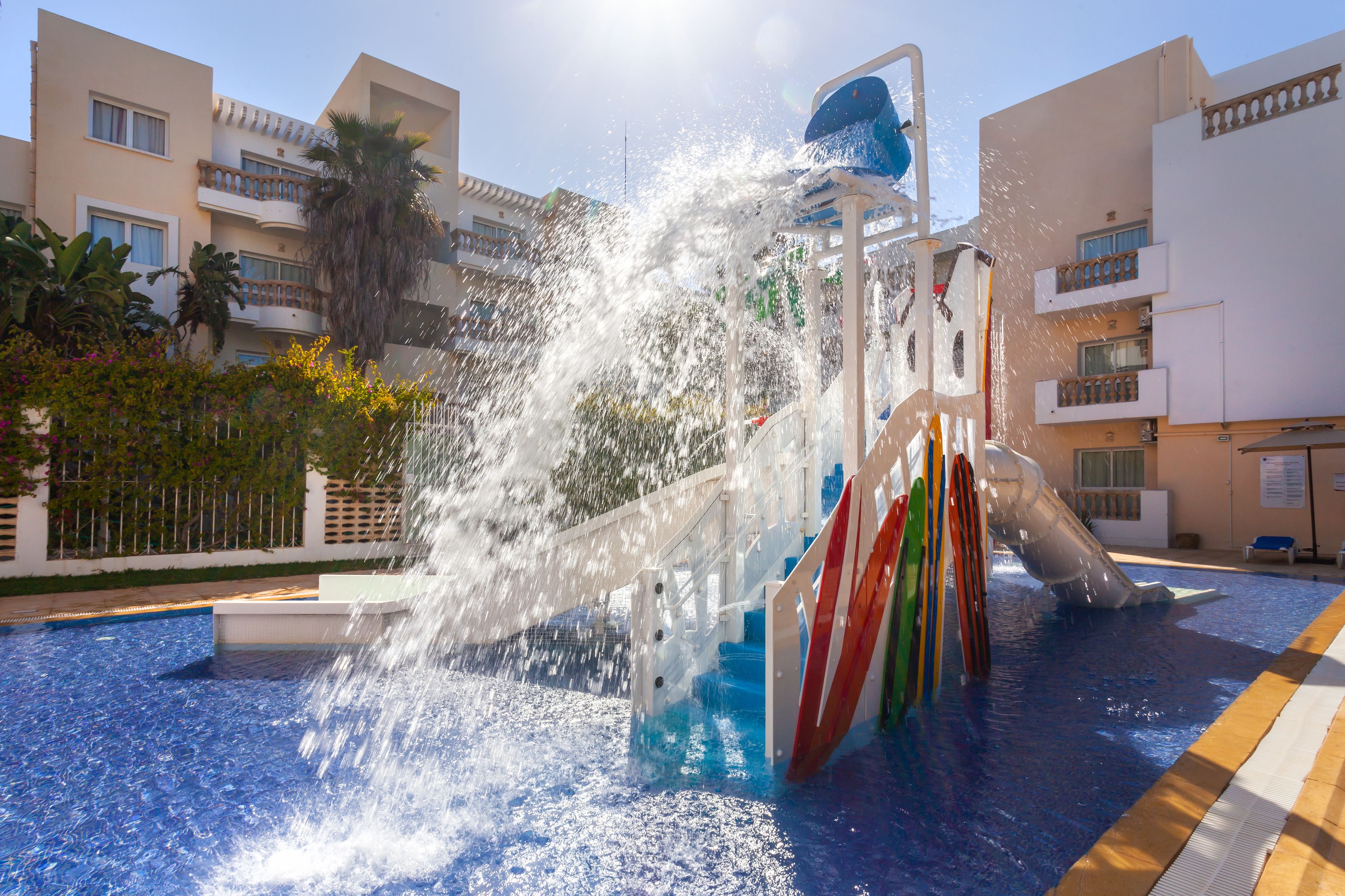 A water park with a large water slide and a pool.