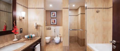 A modern bathroom with a large mirror, a sink, a toilet, and a shower area.