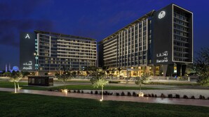 A modern hotel with a prominent 'A' sign, multiple floors, and illuminated signage. - Park Rotana (Abu Dhabi)