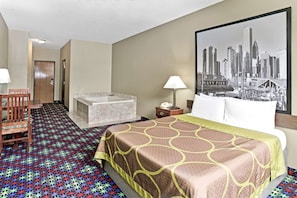 A hotel room with a bed, a desk, a chair, a bathroom, and a cityscape painting on the wall.